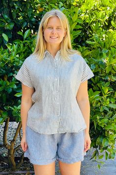 Material: 100% Linen. Description: Relaxed striped Linda linen shirt is easy going with shorts, skirt or jeans. Button down, cap sleeves and straight cut. ONE SIZE Color: Blue/White. Measurements: Bust: 45" Length: 24". Fits US size 6-12. Model is 5'8". Piironki Helsinki is Finnish lifestyle company established 1978. Their focus is relaxed, beautiful and cozy living. Striped Linen Short Sleeve Top, Beach Tops With Striped Collar And Short Sleeves, Classic Striped Short Sleeve Shirt For Spring, Summer Pinstripe Shirt With Button Closure, Striped Linen Top With Button Closure, Pinstripe Button-up Shirt For Summer, Spring Vertical Stripes Short Sleeve Shirt, Vertical Stripes Shirt For Summer Day Out, Pinstripe Short Sleeve Tops For Summer