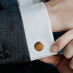 Smooth, shiny Tiger's Eye has been cut into a cushioned disc and surrounded gunmetal plated Sterling Silver to create this set of elegant cufflinks. These heirloom-quality cufflinks add a brilliant shimmer of elegance to any outfit while remaining masculine and dignified. The expert craftsmanship of our Sterling Silver cufflinks ensures long-lasting durability and a classic look that is sure to never go out of style. Classic Brown Cuff Jewelry, Timeless Brown Jewelry For Business, Timeless Brown Business Jewelry, Polished Finish Cufflinks For Anniversary, Business Cuff Jewelry With Polished Finish, Business Jewelry With Polished Finish Cuff, Polished Anniversary Cufflinks, Elegant Gunmetal Jewelry For Formal Occasions, Modern Brown Jewelry For Business