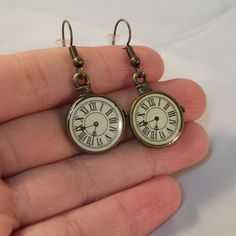 These Beautiful Pocket Watch Clock Dangle Earrings Are Made Of Gold Bronze Alloy And On Hypoallergenic Hooks That Will Not Hurt Your Ears. Brand New And Never Been Worn. Lead And Nickel Free. Rubber Backs Included. These Fine Quality Earring Are Perfect For Everyday Wear Or A Special Gift. Get An $18 Free Gift Of Your Choice In My Listings With Purchase Of Two Or More Items. Please Send Offers And Questions. Charm Clocks: 23 X18mm Or .90" X .70" Clock Earrings, Clock Accessories, Radium Girls, Handmade Jewelry Business, Gold Clock, Watch Clock, Handmade Wire Jewelry, Vintage Clock, Pretty Stuff