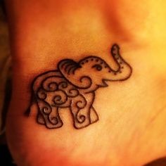 an elephant tattoo on the foot of a person