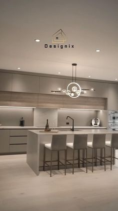 a modern kitchen with an island and bar stools