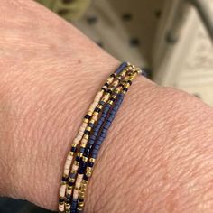 a close up of a person's arm wearing a bracelet with beads on it