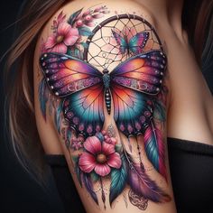 a woman's back with a colorful butterfly and dream catcher tattoo on it