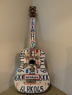 a guitar made out of license plates and magnets