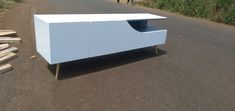 a white cabinet sitting on the side of a road