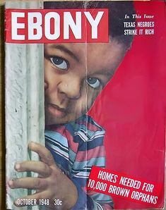 the front cover of ebony magazine showing a young boy peeking out from behind a curtain