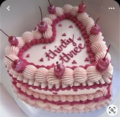 a heart shaped birthday cake with pink frosting and cherries on the top that says future love