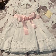 18 Month Beautiful Dress. Brand New With Tags. Dress Has A Pink Sash And Matching Under Pants. Cute Cotton Baptism Dress For Dress-up, White Sleeveless Cotton Baptism Dress, Pink Sash, Ashley White, Laura Ashley Dress, Antique Doll Dress, Under Pants, Laura Ashley, Kids' Dresses