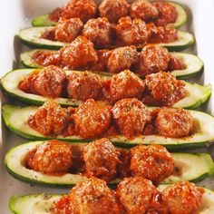 several stuffed cucumbers with meatballs on them