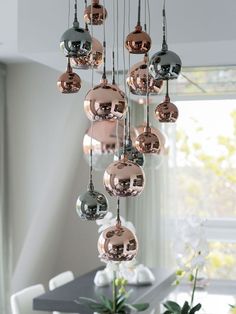 a chandelier with many shiny balls hanging from it