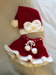 two crocheted hats and diaper covers on a bed