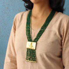 I made a Laxmi ji pendant using brass and added a layer of gold. I wanted to create a unique Indian handmade necklace. The necklace is decorated with small glass beads that are enhanced with gold plating, making it even more beautiful. It's 30 inches long and comes with an adjustable thread. The design is perfect for weddings, and the dangling pearls add an extra charm. Feel free to message me if you want any changes. I'm open to custom orders. Festive Brass Temple Jewelry Necklaces, Amulet Style Pendant Necklace With Beaded Chain, Amulet-style Pendant Necklace With Beaded Chain, Gold Beaded Long Temple Necklace, Gold Bohemian Long Kundan Necklace, Spiritual Long Necklace With Dangling Beads, Handmade Traditional Necklace With Rectangular Pendant, Traditional Handmade Necklace With Rectangular Pendant, Spiritual Gold Kundan Necklace With Polished Beads