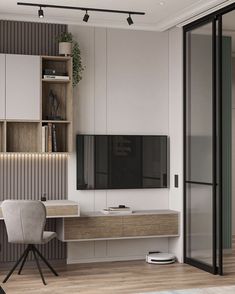 a living room with a tv, desk and bookcases on the wall next to a sliding glass door