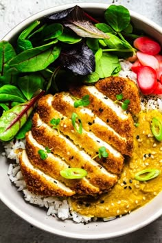 a white bowl filled with rice, meat and veggies on top of it