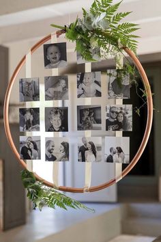 a circular frame with photos and greenery hanging from it