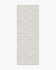 a white rug with an abstract design on the bottom, and a light gray background