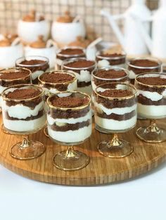 small desserts are arranged on a wooden platter