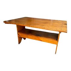 a wooden table sitting on top of a white wall