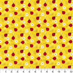 a yellow background with red and white ladybugs on it's side, next to a ruler