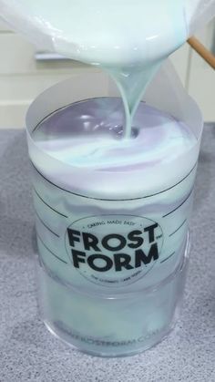 a container filled with frosting sitting on top of a counter