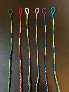 four crocheted toothbrushes are lined up on a table