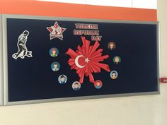 there is a sign that says turkish republic day with pictures on the wall behind it