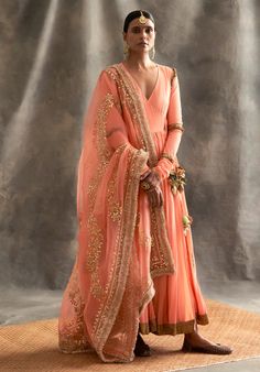 Editor's Note Peach Cotton Mul Angrakha With Metallic Lampi Godet, The Tie-ups Have Intricate Hand Made Animals For Tassels. The Silk Organza Dupatta Has Intricate Gota Patti Dori Hand Embroidery Edged With Traditional Kiran Fabric: Cotton, SIlk Organza Color: Peach Care: Dry Clean Only About the Designer Itrh makes a high-end luxury Indian ethnic wear made using exquisite and endangered age-old crafts such as kalamkari, madhubani, chikankari, zardozi, and gota weaving. The focus of the house is Peach Suit Indian, Peach Suit, Glitter Suit, Chanderi Dupatta, Silver Jacket, Elegant Maxi Dress, Amritsar, Anarkali Suit, Skirt And Blouse