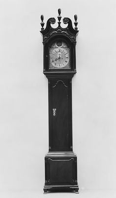 an old black grandfather clock against a white background