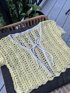 a crocheted sweater sitting on top of a chair