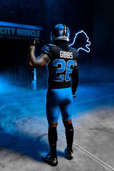 a football player is standing in the dark