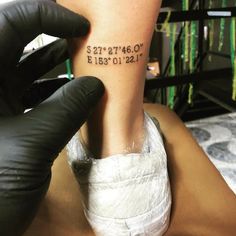 someone is getting their foot tattooed with words