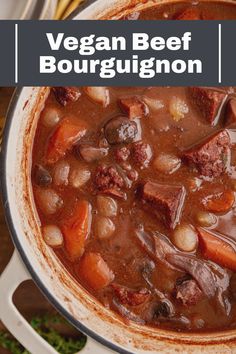 a pot full of beef bourguggnon soup with potatoes and carrots on the side