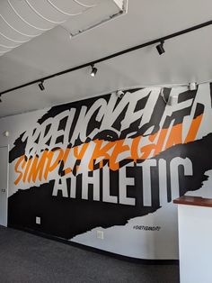 the wall is decorated with an orange and black design on it's sidewall