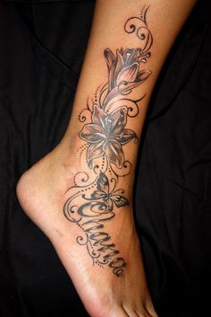 a woman's foot with a flower tattoo on it