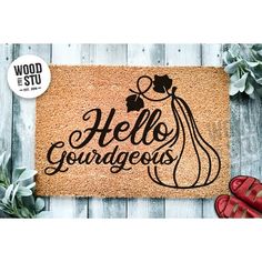 a door mat with the words hello gourdgeus on it and red shoes next to it