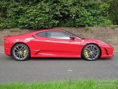 a red sports car is parked on the street