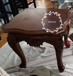 a wooden table with the words before painted on it