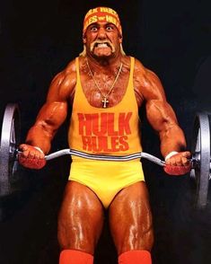 a man in yellow wrestling suit holding a barbell