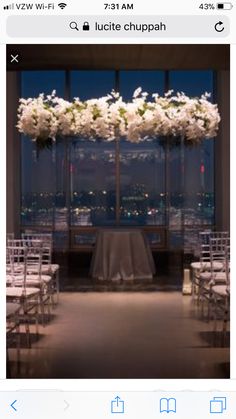 a room filled with lots of white flowers and chairs