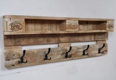 a wooden shelf with hooks on it