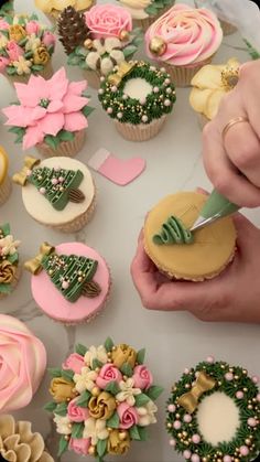 a person is decorating cupcakes with flowers