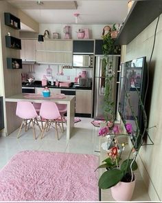 a pink rug in the middle of a room with chairs and a table on it