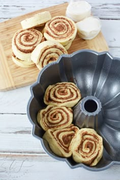 several cinnamon rolls in a bundt pan on a cutting board