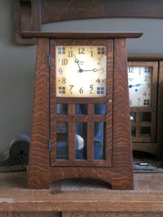 a wooden clock sitting on top of a table