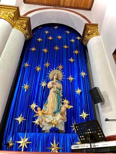 the altar is decorated with gold stars and an image of virgin mary on blue curtain