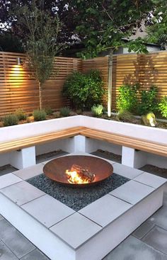 a fire pit sitting on top of a cement block