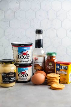 an assortment of food items sitting on a counter next to eggs, mayonnaise and other condiments