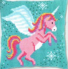 a cross stitch pillow with an image of a pink unicorn on the front and blue background