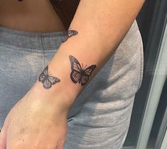 a woman with a butterfly tattoo on her arm