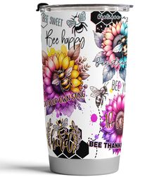 a white tumbler cup with colorful flowers and bees on the side that says bee happy